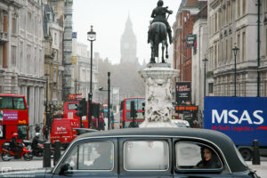A taxi passenger taking in a view of the surroundings on Trafalgar Square, London, England.
