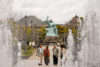 Framed by the water jets of a fountain at Nagasaki Peace Park in Japan, folks are seen having a pensive talk.