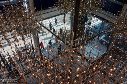 A pattern study of an elaborate set of ceiling lights and the ground-level scenery at a building in the Ginza district of Tokyo, Japan.