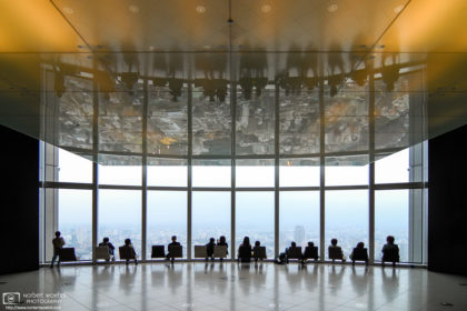 Visitors to the 52nd floor observation deck at Mori Tower in Roppongi, Tokyo, are enjoying a view of the city.