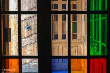 A pattern of colorful glass windows around the main entrance of Mariatrost Basilica in Graz, Austria.