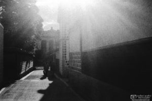 Bright sunlight flooding a side street in the historical Bikan District of Kurashiki in Okayama Prefecture, Japan.