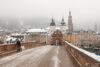 Walking the dog on a cold winter day at Alte Brücke (Old Bridge) in Heidelberg, Germany.