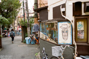A makeshift exhaust pipe and a brick-pattern shirt are just two of the many details to be found in this scene from a street corner in Nakano, Tokyo, Japan.