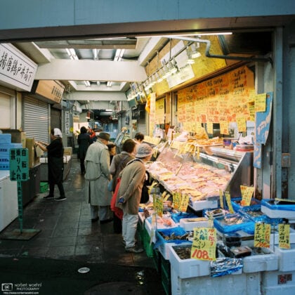 Customers are looking at meat and seafood offered by this shop in Shimo-Takaido, Setagaya, Tokyo, Japan.