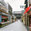 Approaching Kawasaki Daishi (Heiken-ji) Temple in Kawasaki, Japan, along a road lined with shops.