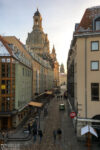 A southbound view along Münzgasse towards the dome of Frauenkirche in Dresden, Germany. The darker tower in the back is part of the new City Hall (Neues Rathaus).