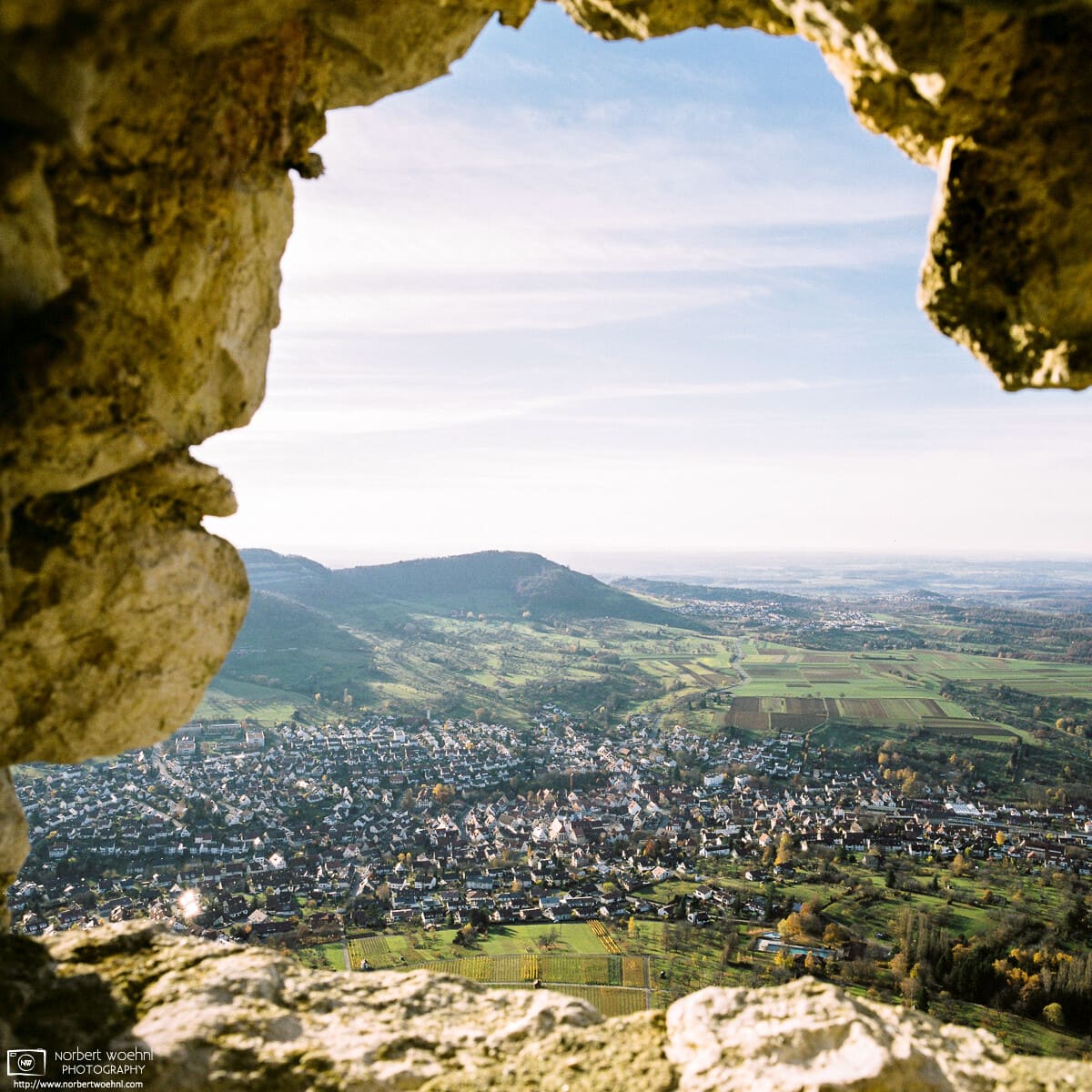 A view of the pleasant scenery around Hohenneuffen Castle in southwestern Germany, framed by the remains of an old castle wall.