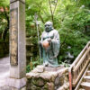 A smiling Buddha statue along the ascent to the main hall of Nanzoin Temple in Sasaguri, Fukuoka, Japan.