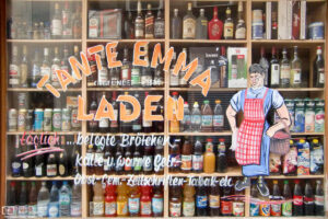 Window view at the drinks selection of a traditional mom-and-pop store in Nuremberg, Germany.