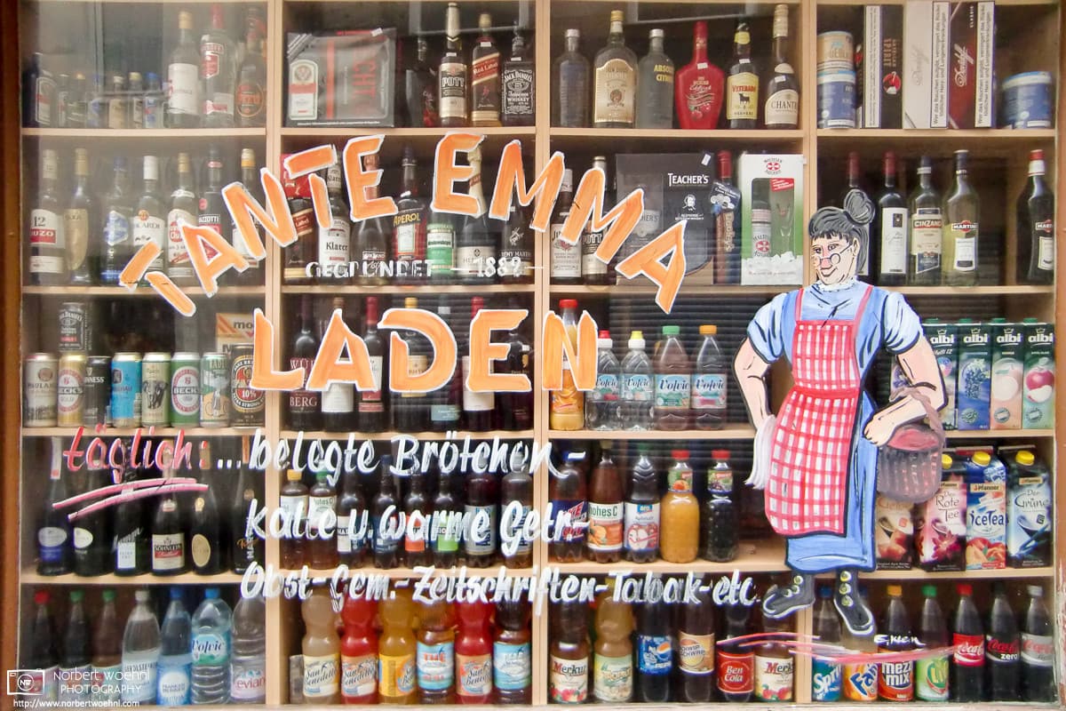 Window view at the drinks selection of a traditional mom-and-pop store in Nuremberg, Germany.