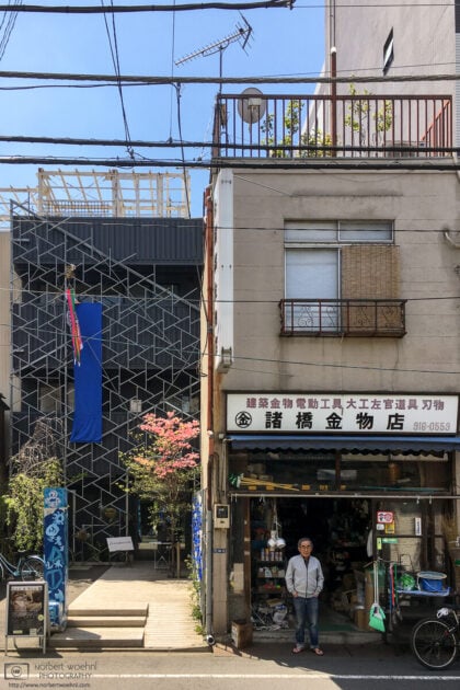 A shop owner is eyeing a foreign photographer in the Takinogawa area of Kita-ku, Tokyo, Japan.