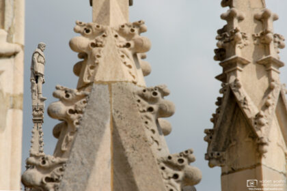 A statue on top of one of the rooftop spires at Duomo, the glorious cathedral at Milan, Italy.