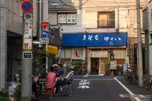 Locals having a casual chat on a hot summer evening in the Taito ward of Tokyo, Japan.