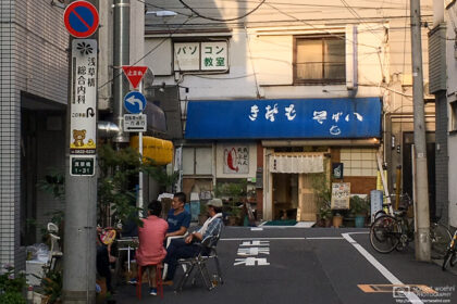 Locals having a casual chat on a hot summer evening in the Taito ward of Tokyo, Japan.